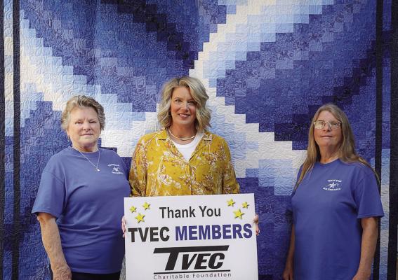 The Trinity Valley Electric Cooperative (TVEC) Charitable Foundation recently awarded a $2,000 grant to the Texas Star Quilters Guild. This year’s raffle quilt was the ‘Blue Lily.’ Pictured were Janet Cole, left, and Cathy Anderson, right, the creators of the ‘Blue Lily.’ Also shown was Kari Wilmeth from TVEC. Not pictured was Cathy McCoy, the quilter. Raffle tickets can be purchased at the Van Zandt County/Sarah Norman Library. Courtesy photo